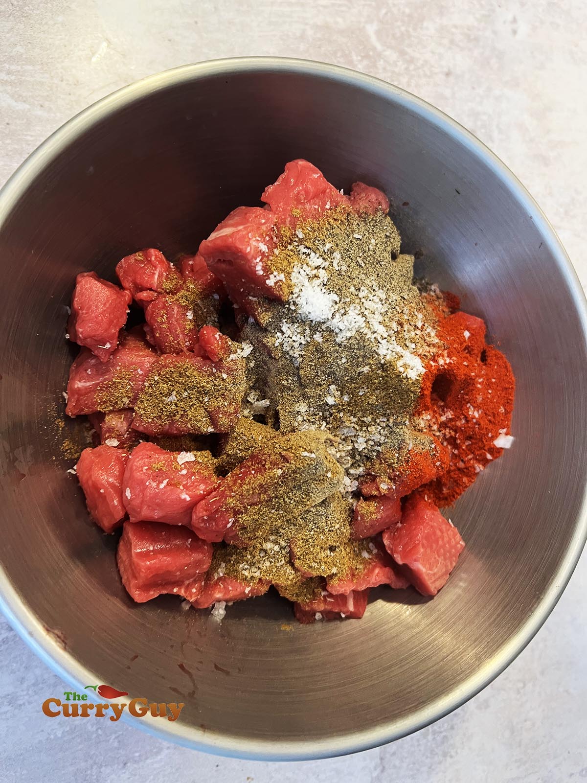 Adding dry spices and salt to beef
