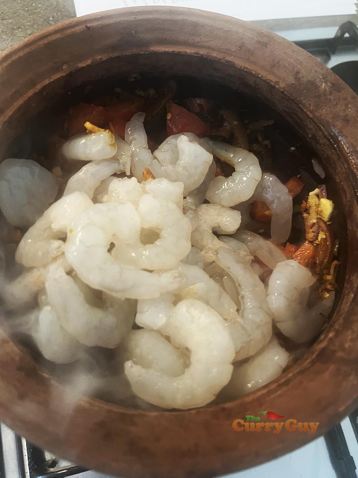 Adding prawns to pot