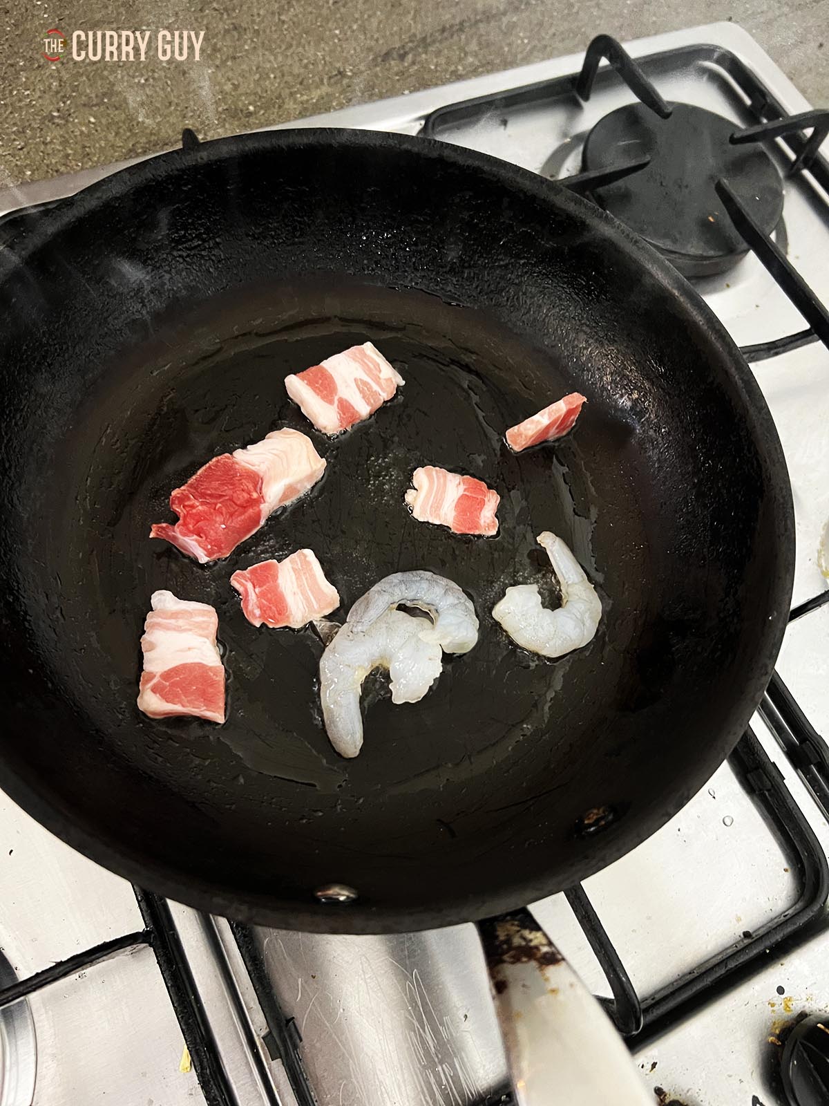 Cooking pork belly and shrimp in a pan.
