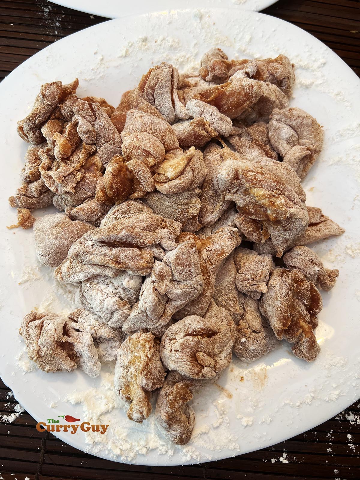 Dusting chicken with the flour