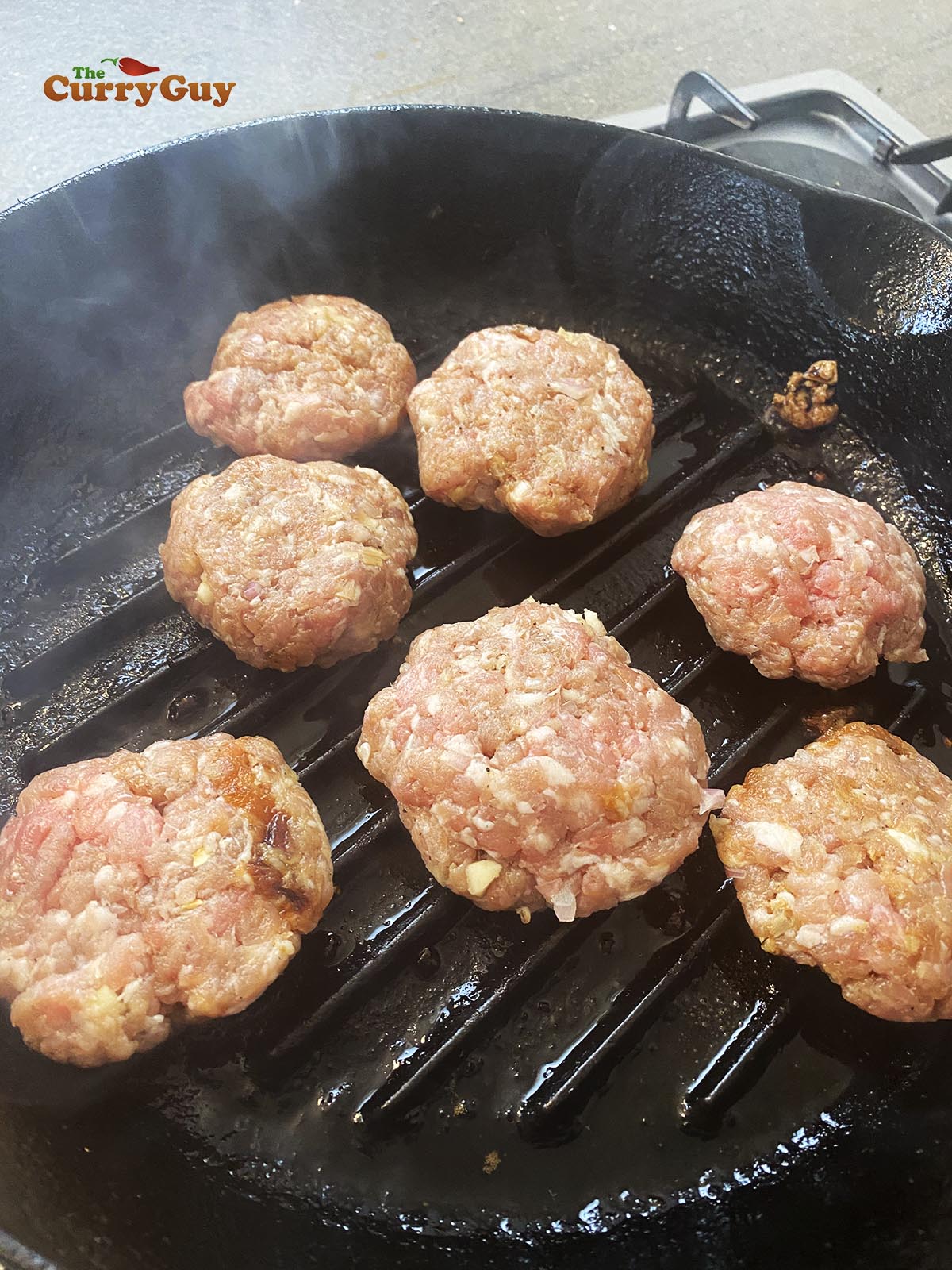 Frying pork patties.