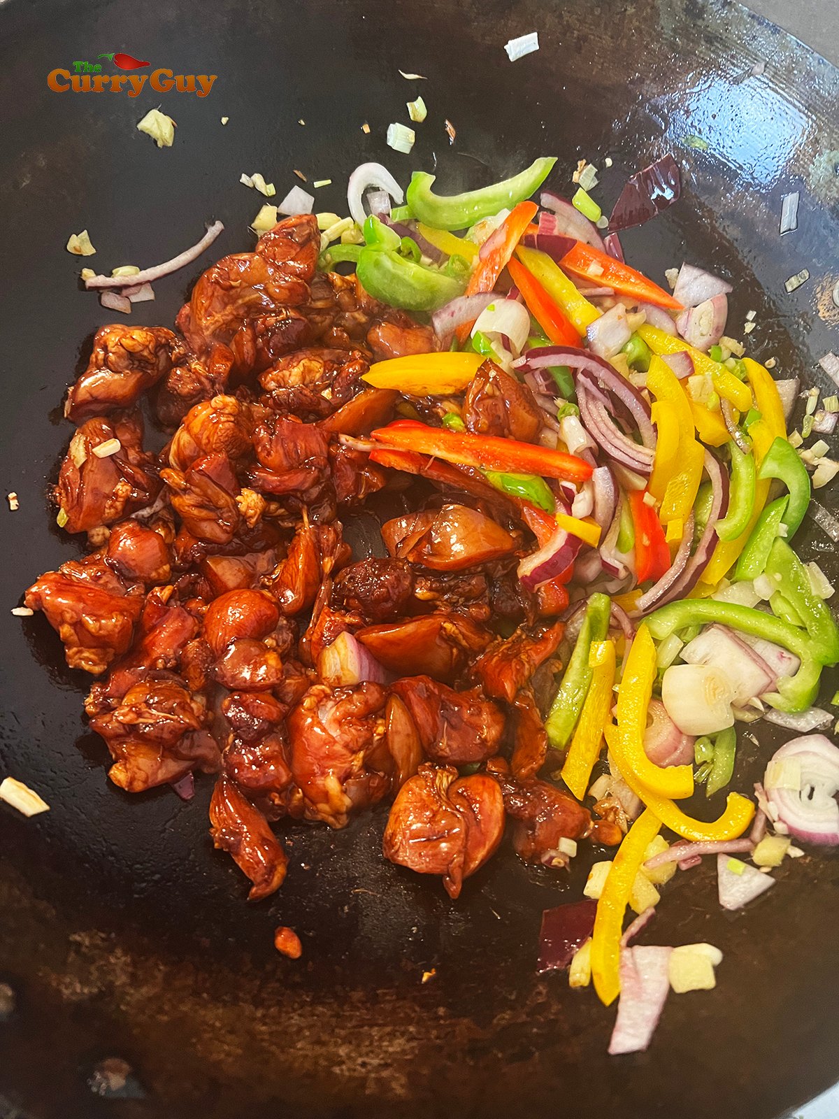 Frying chicken and vegetables. 