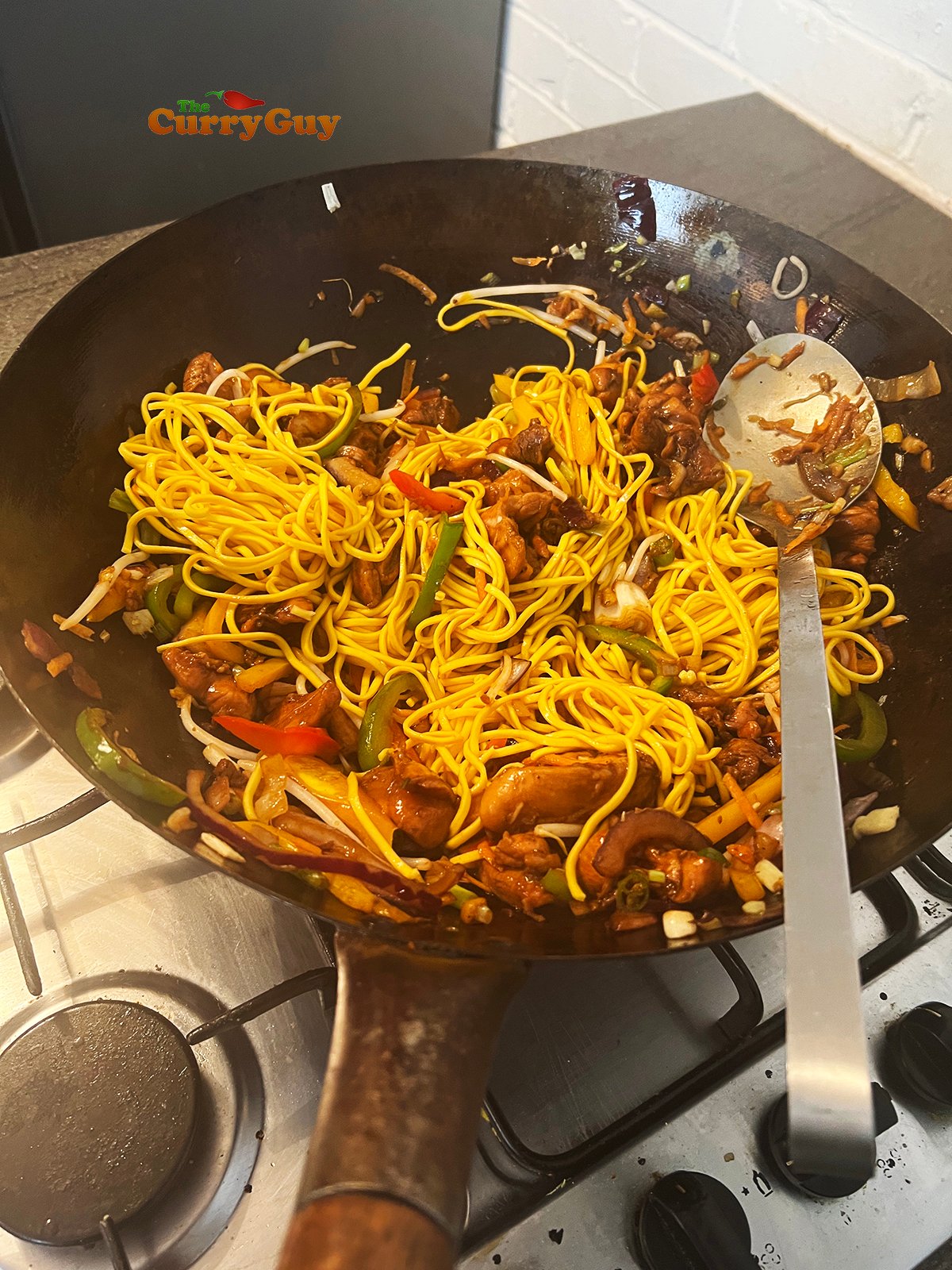 Adding noodles to the wok
