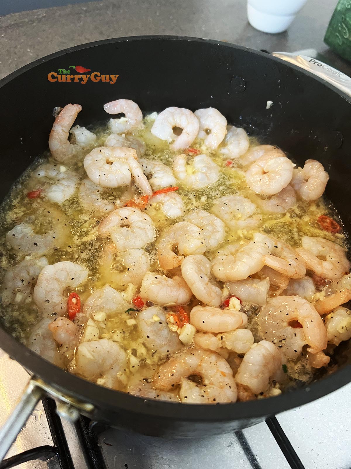 Adding the prawns to gambas pil pil