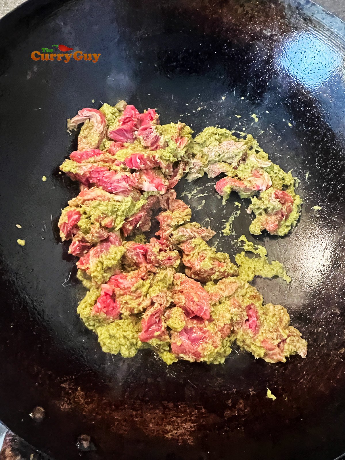 Stirring meat and curry paste together