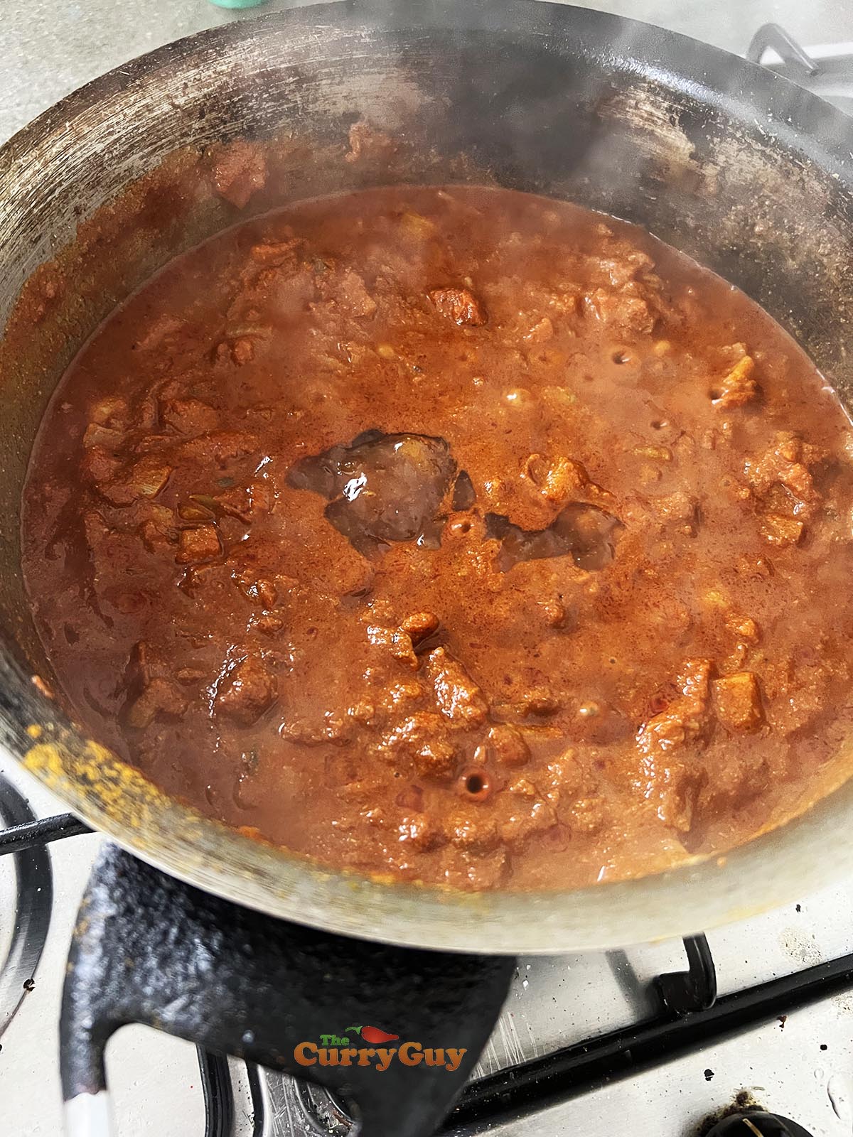 Adding mango chutney to the sauce