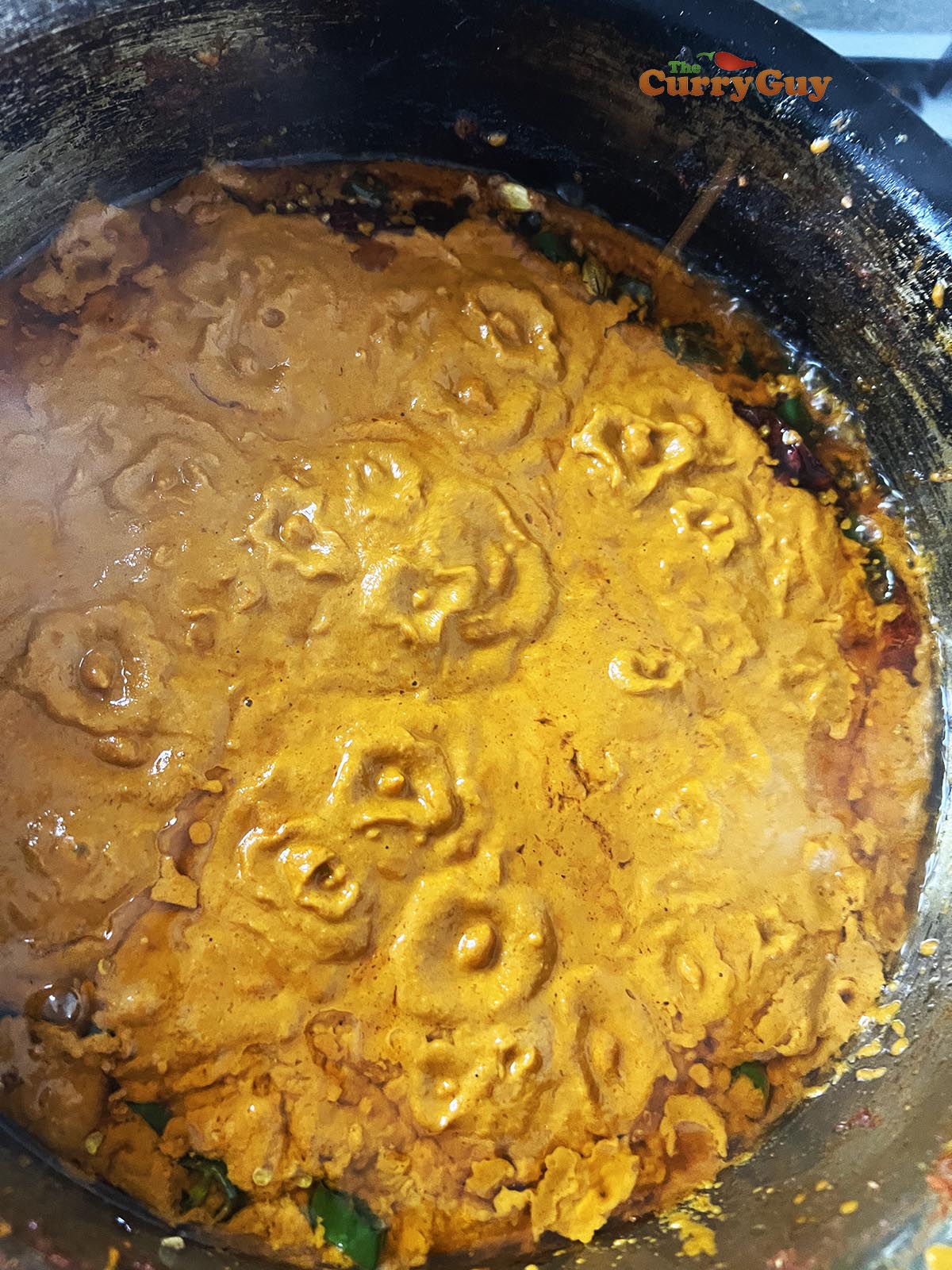 Simmering the blended sauce in the pan