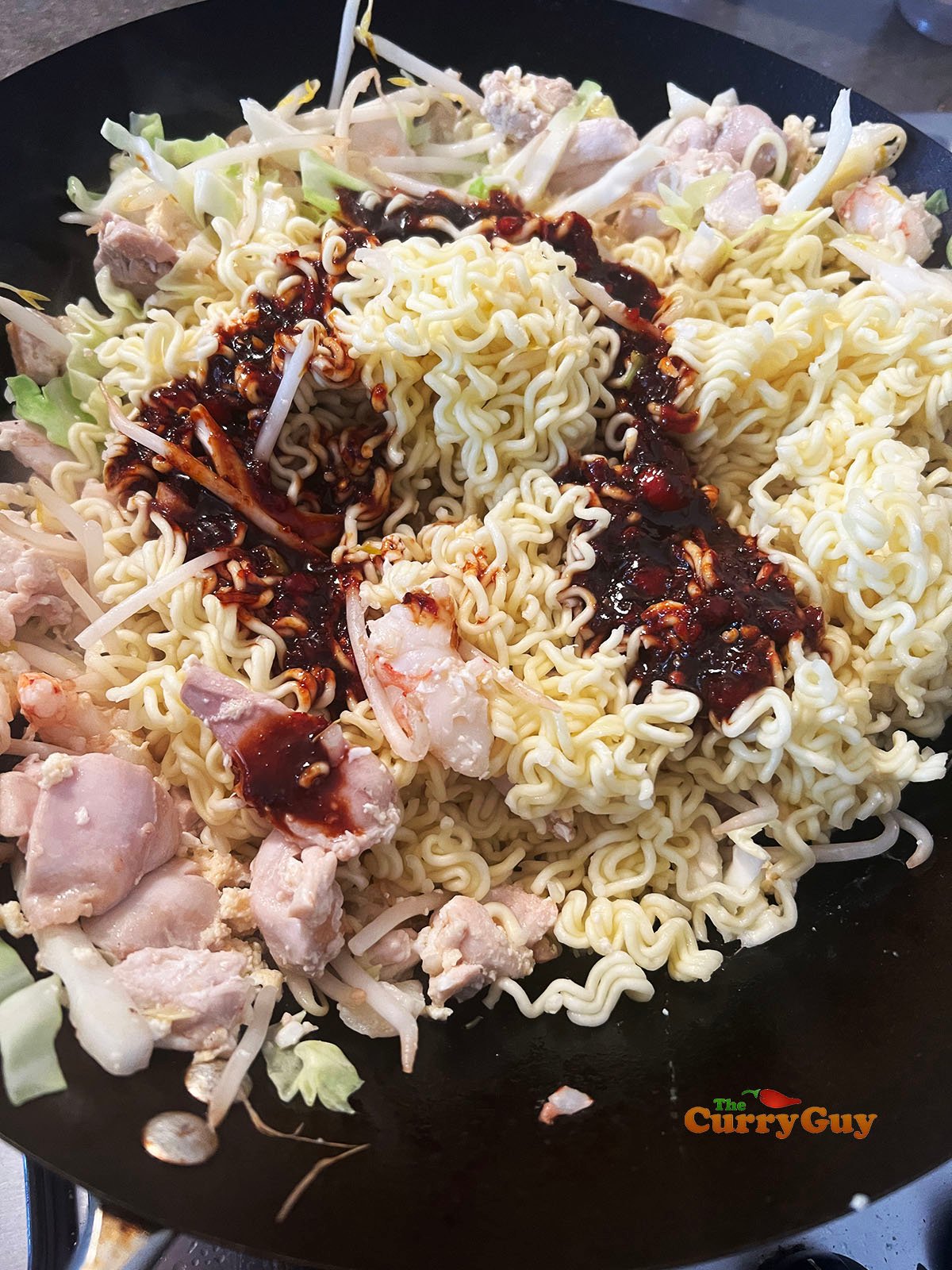 Adding sauce to the wok