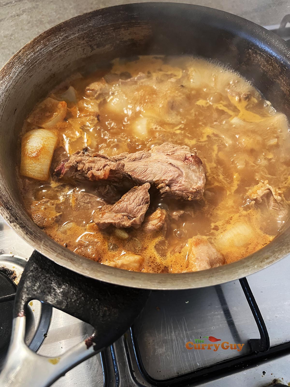 Simmering lamb in stock