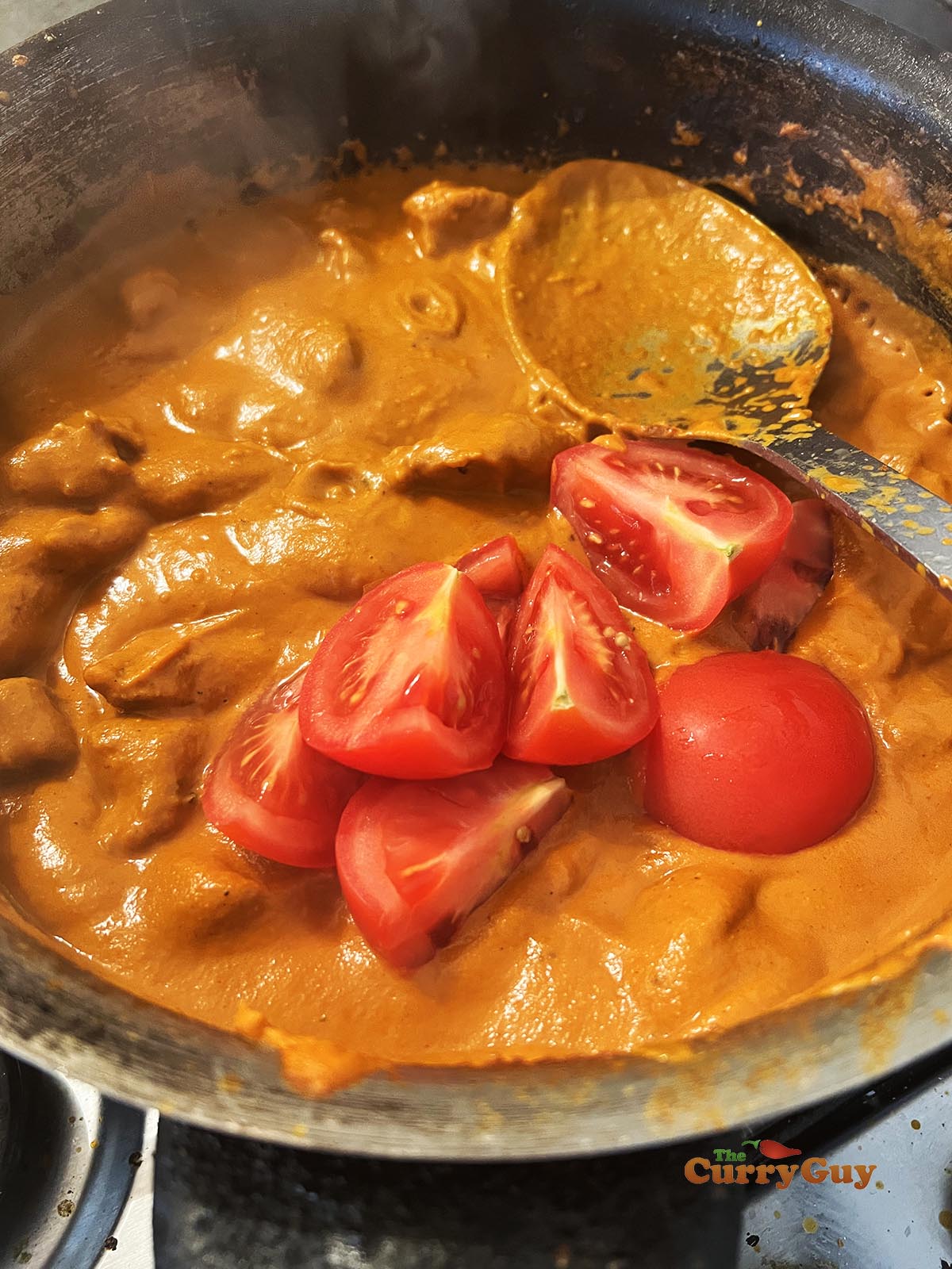 Adding tomatoes to the sauce