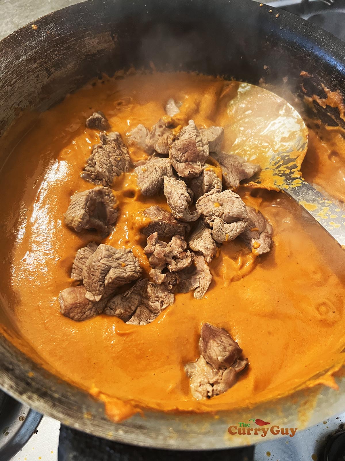 Adding lamb to the pan