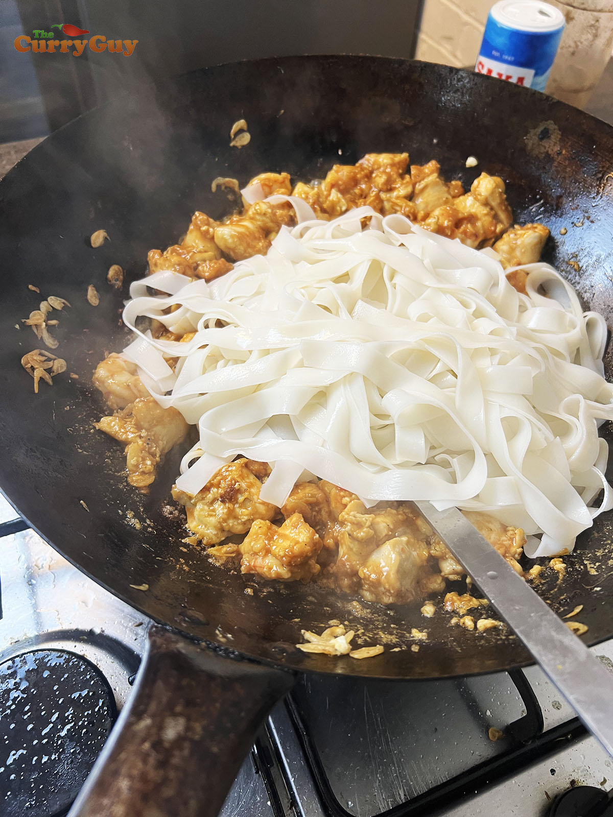 Stirring rice noodles into the pad thai
