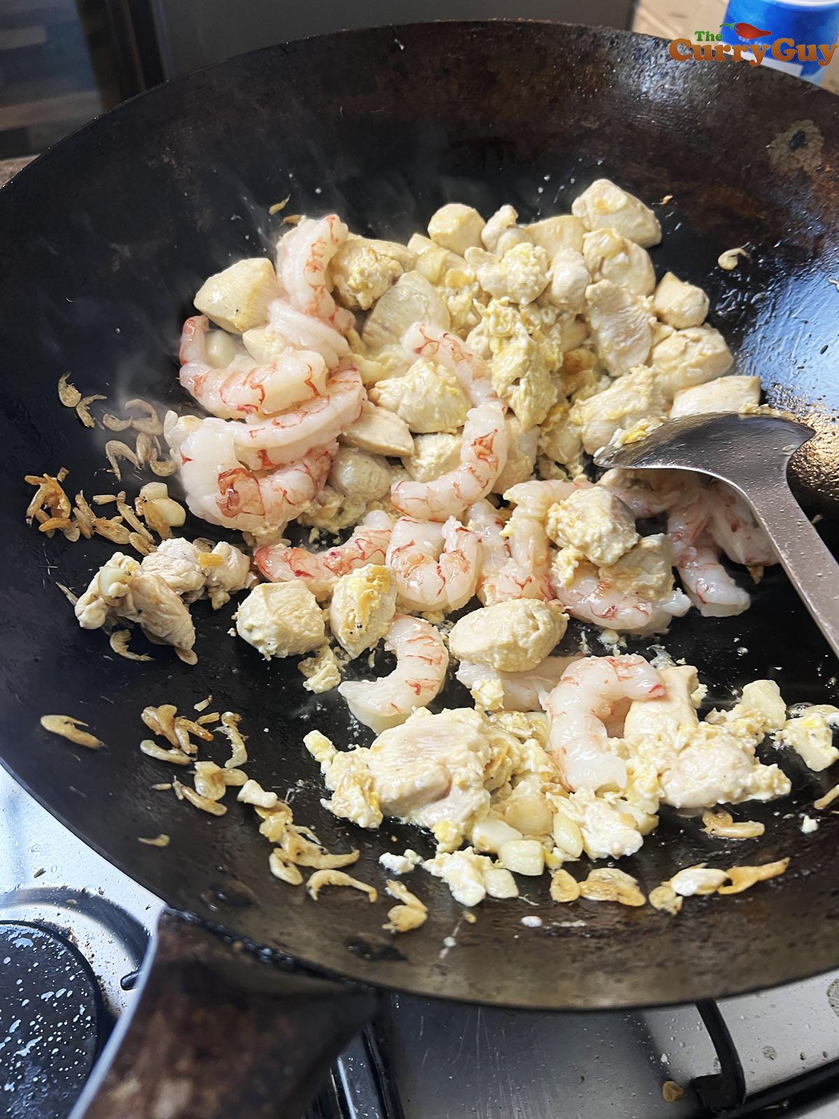 Adding jumbo prawns to the wok