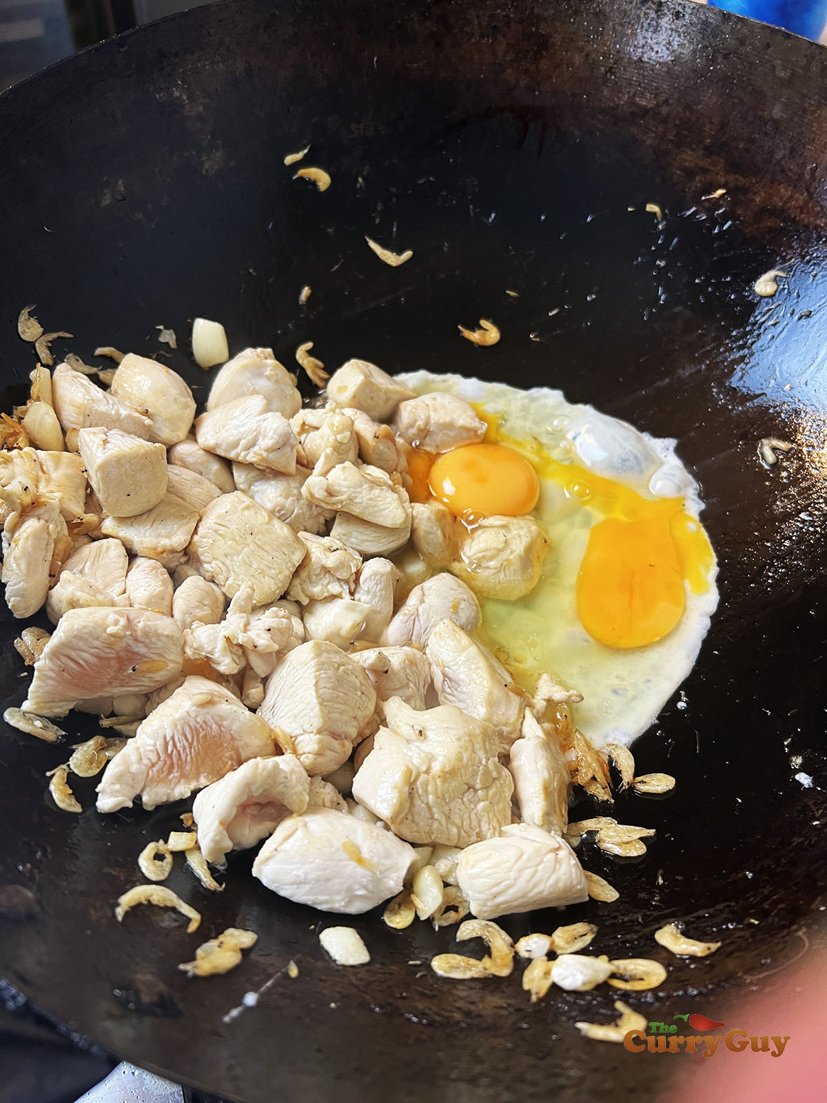 Adding the eggs to the wok