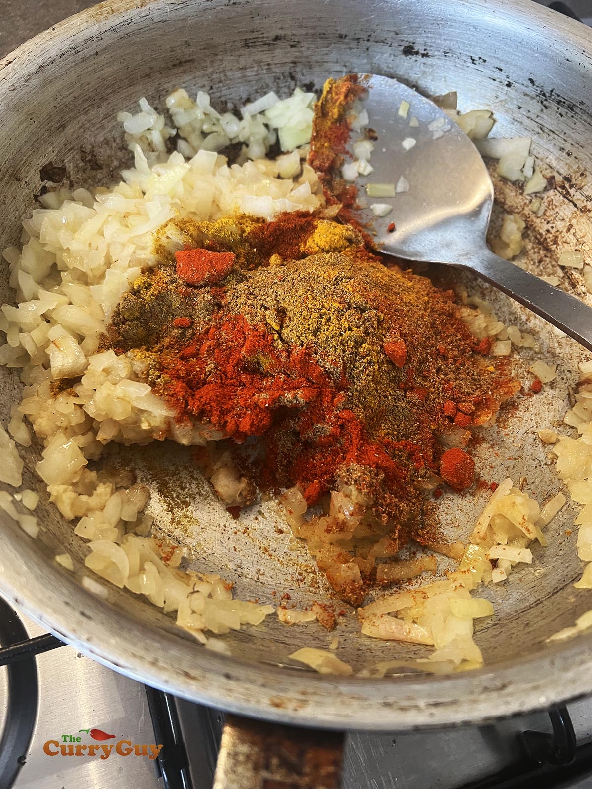Adding ground spices to the pan