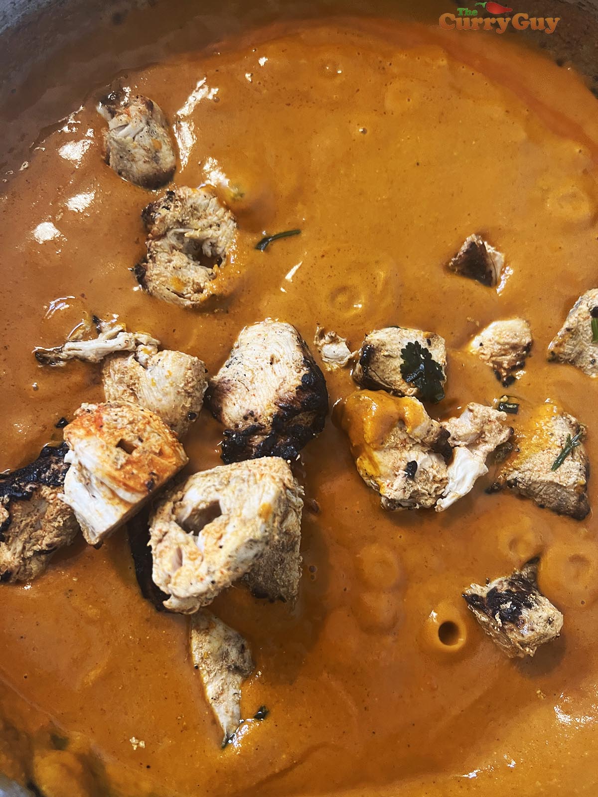 Adding chicken tikka to pan