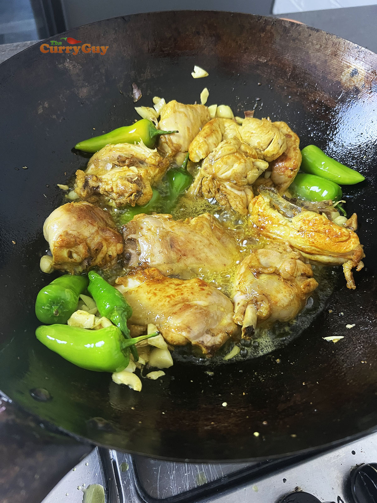 Cooking chillies and chicken in the ghee