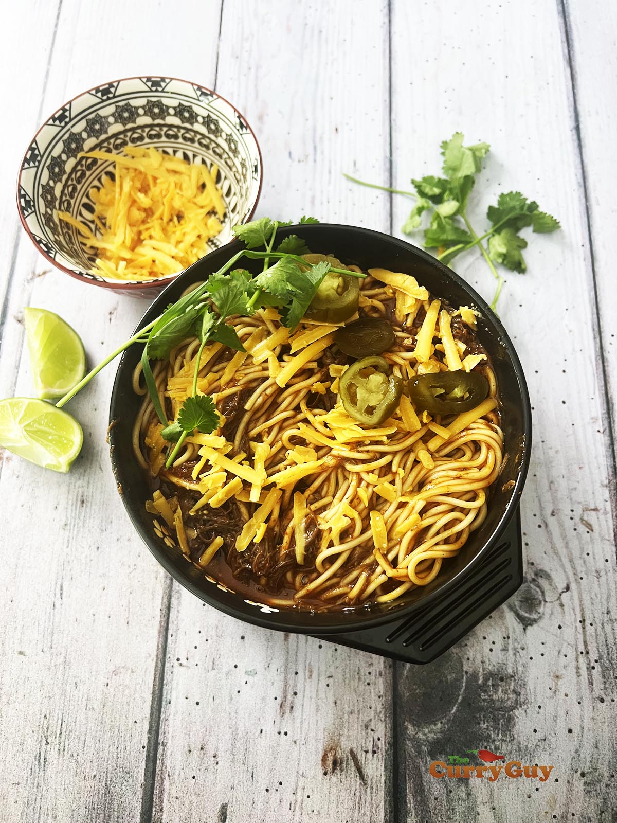 Birria ramen being served at the table