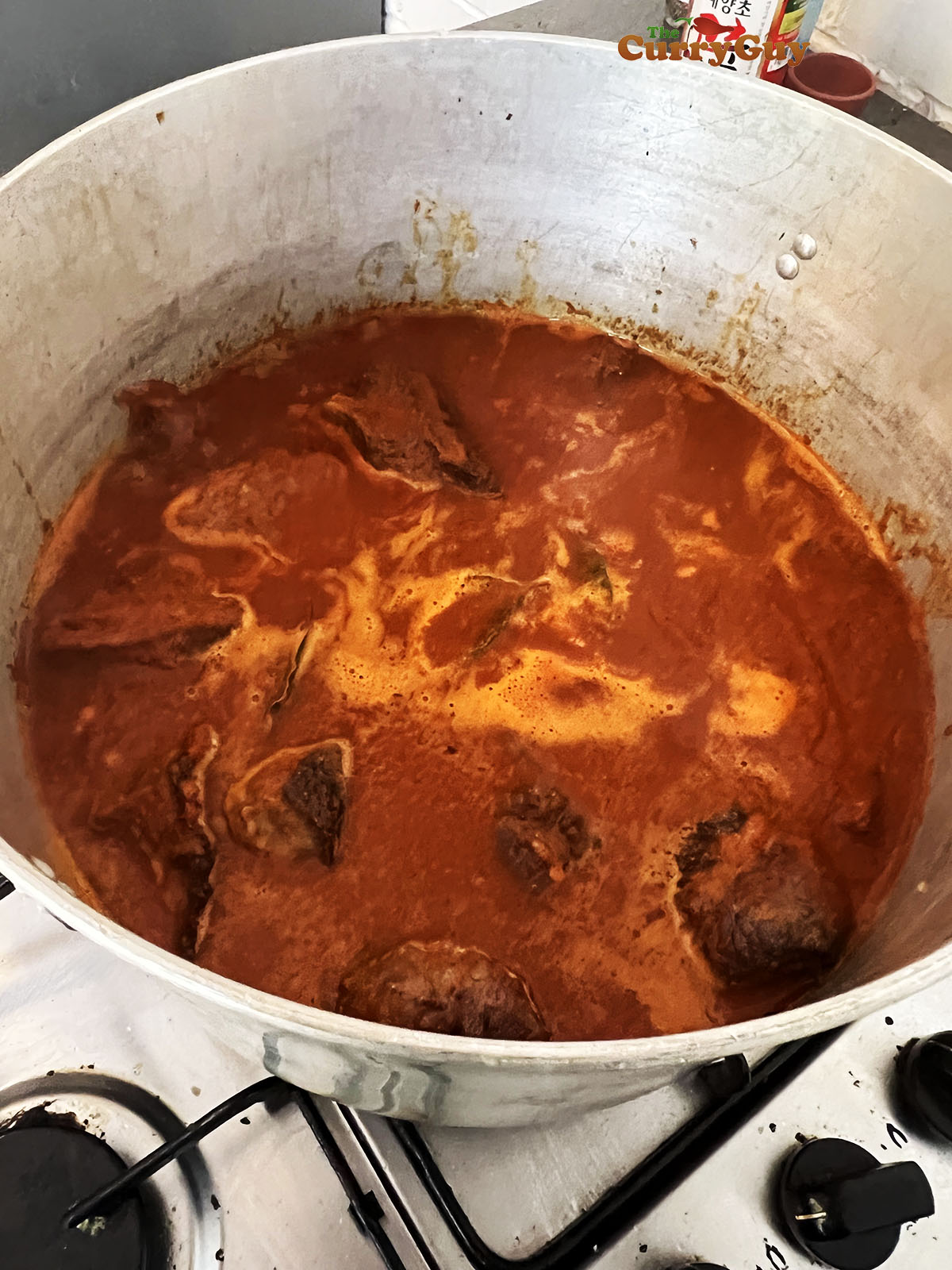 Adding sauce and water to cover the meat in the pot