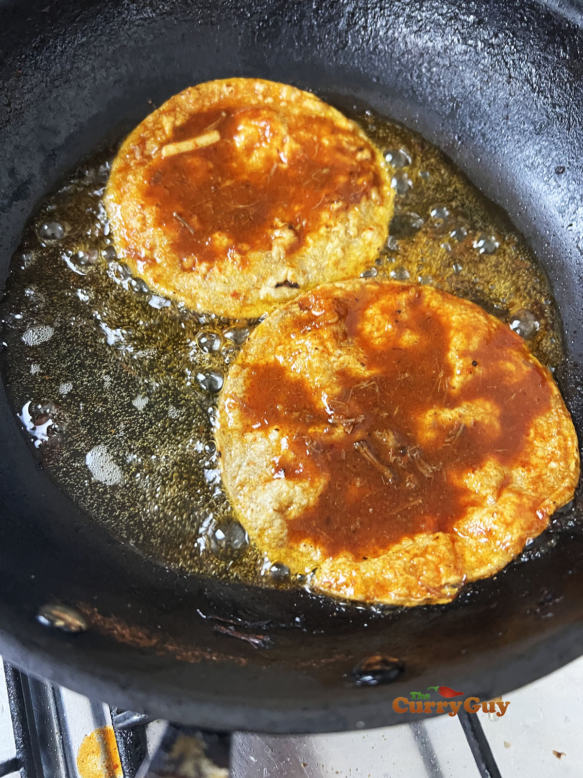 Frying birria tacos