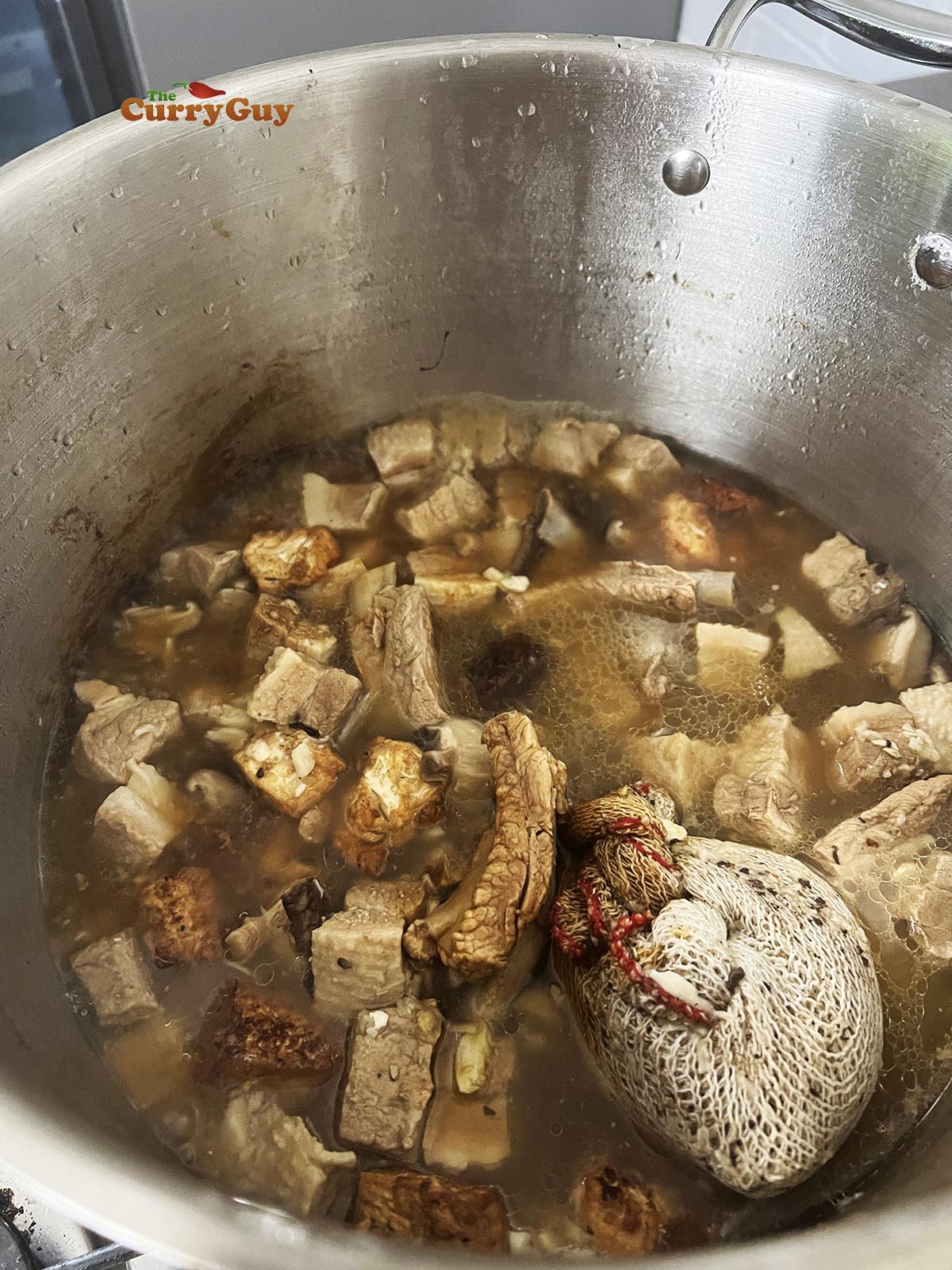 Adding soy sauce and fish sauce to the stock.