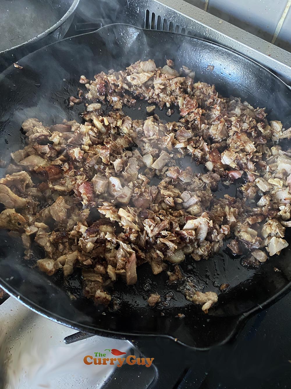 Frying pork until caramelised and crisp