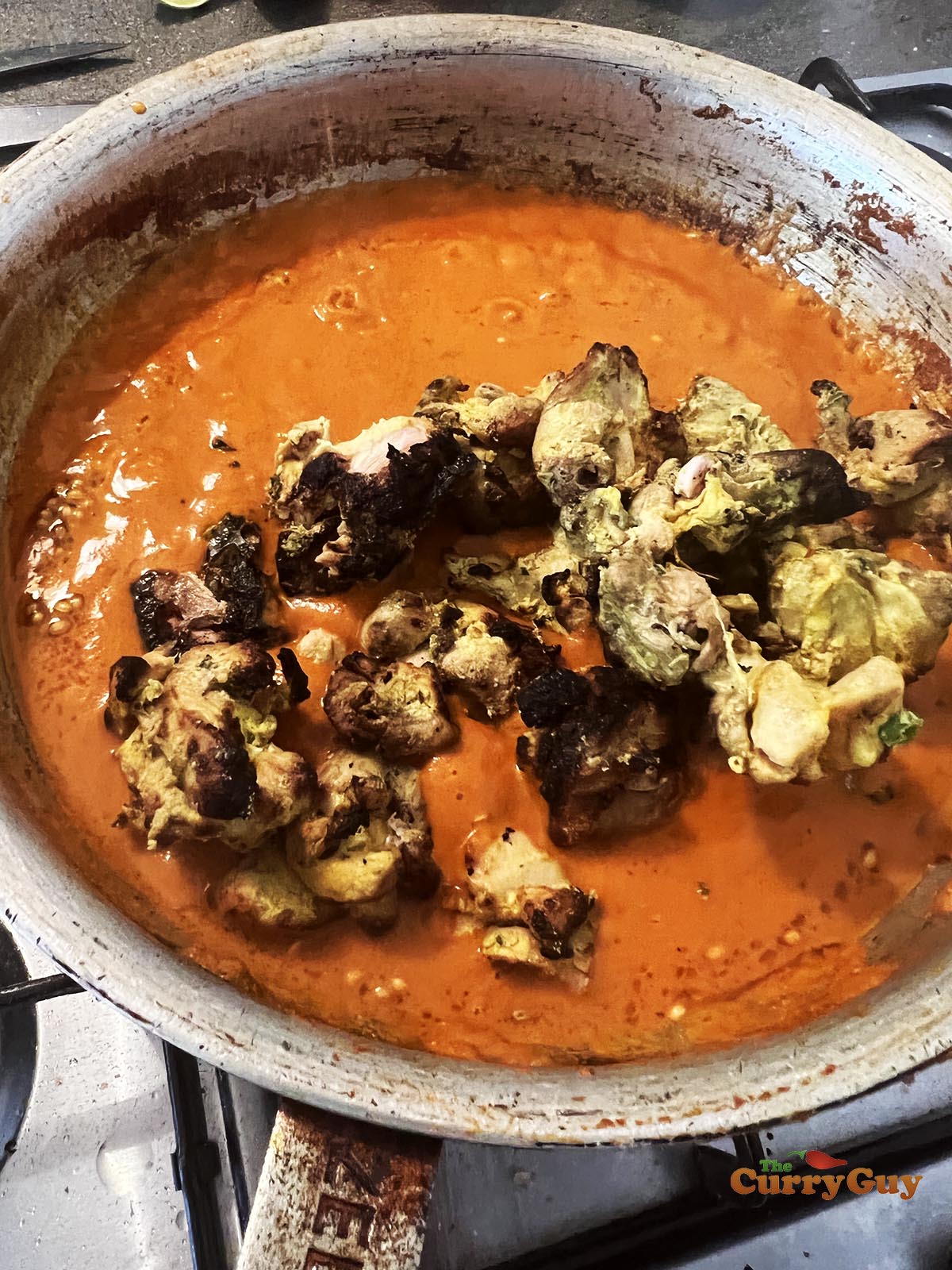 Adding chicken tikka to the pan