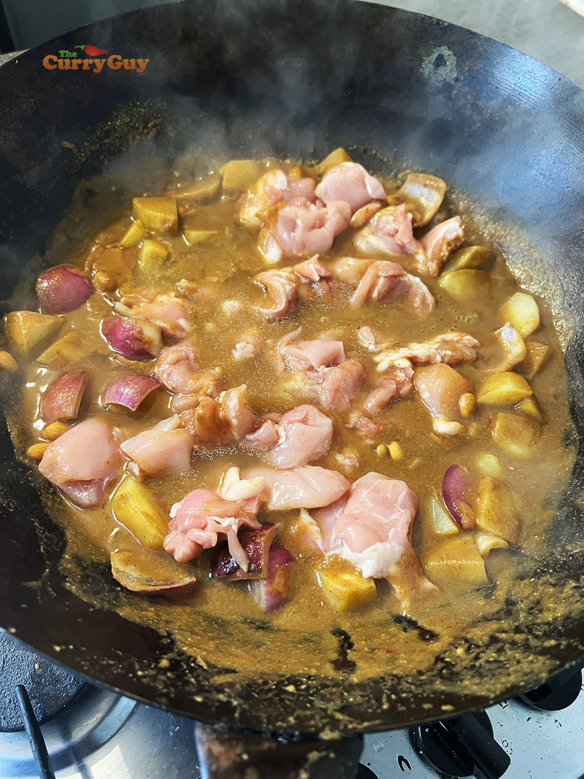 Adding chicken to the wok