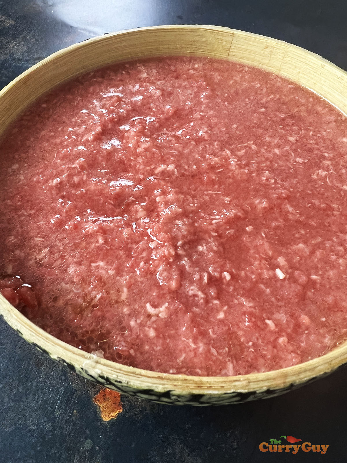 Mixing water with beef.