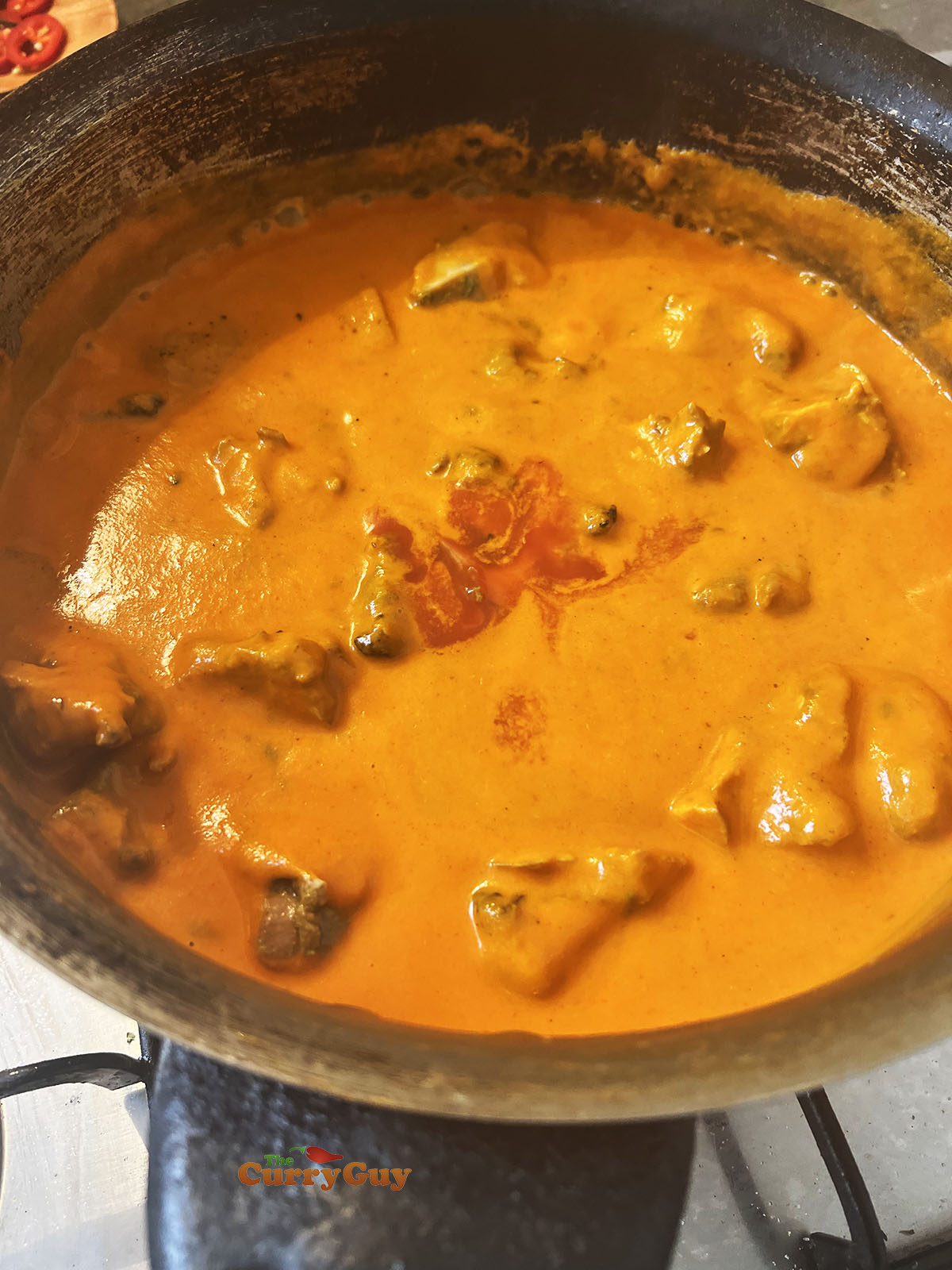 Adding tamarind sauce and chicken to the pan