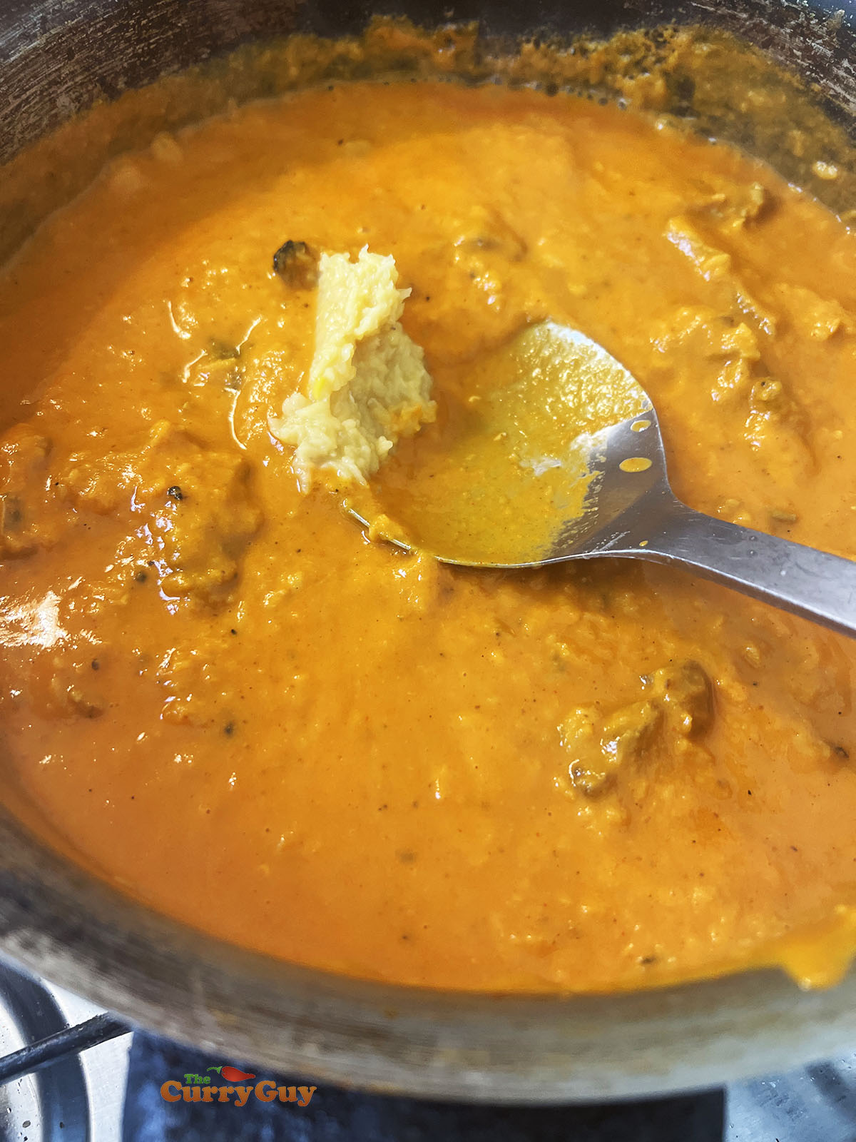 Adding cooked lentils to the pan
