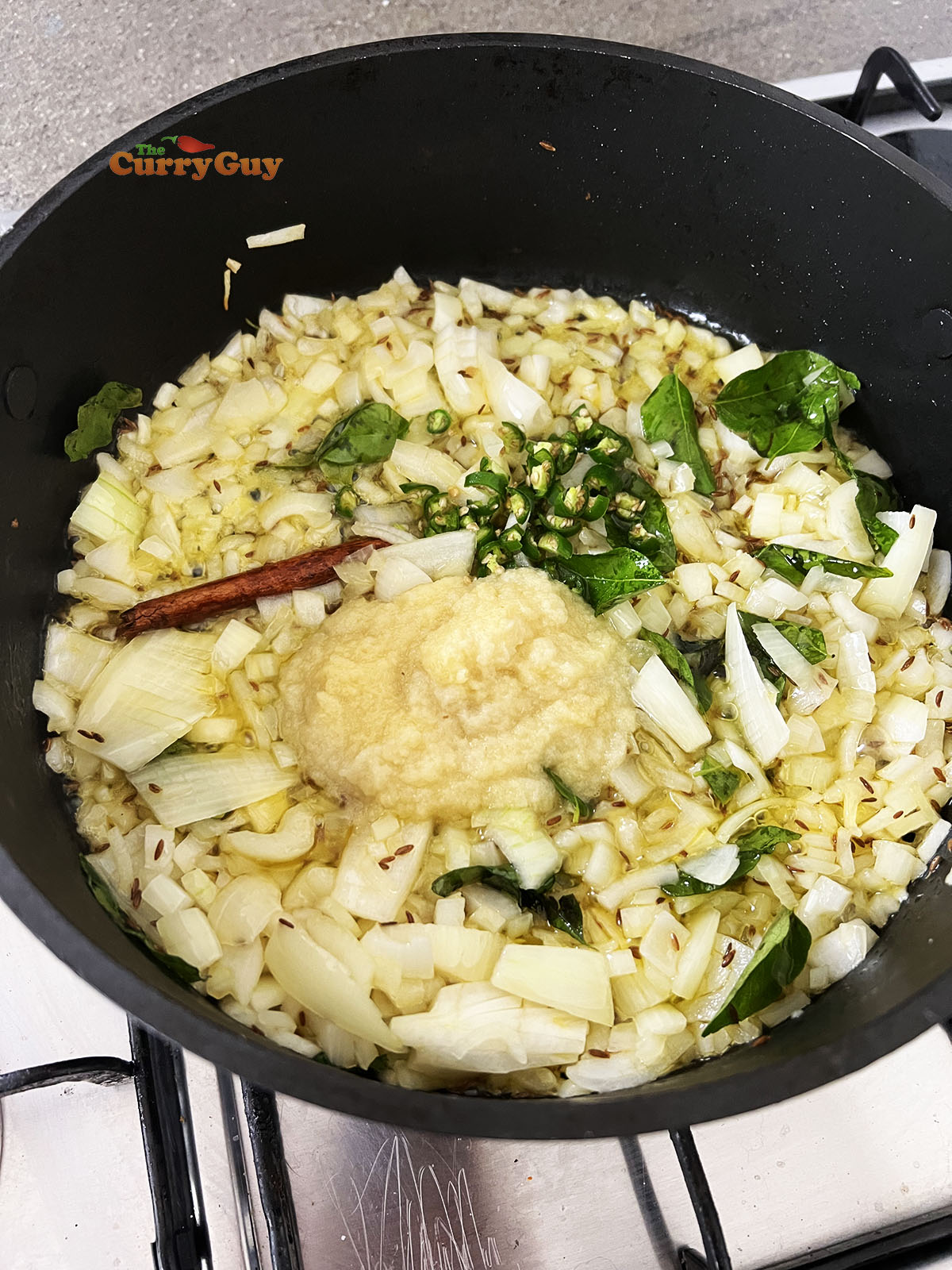 Adding the garlic and ginger paste and chillies to the pan
