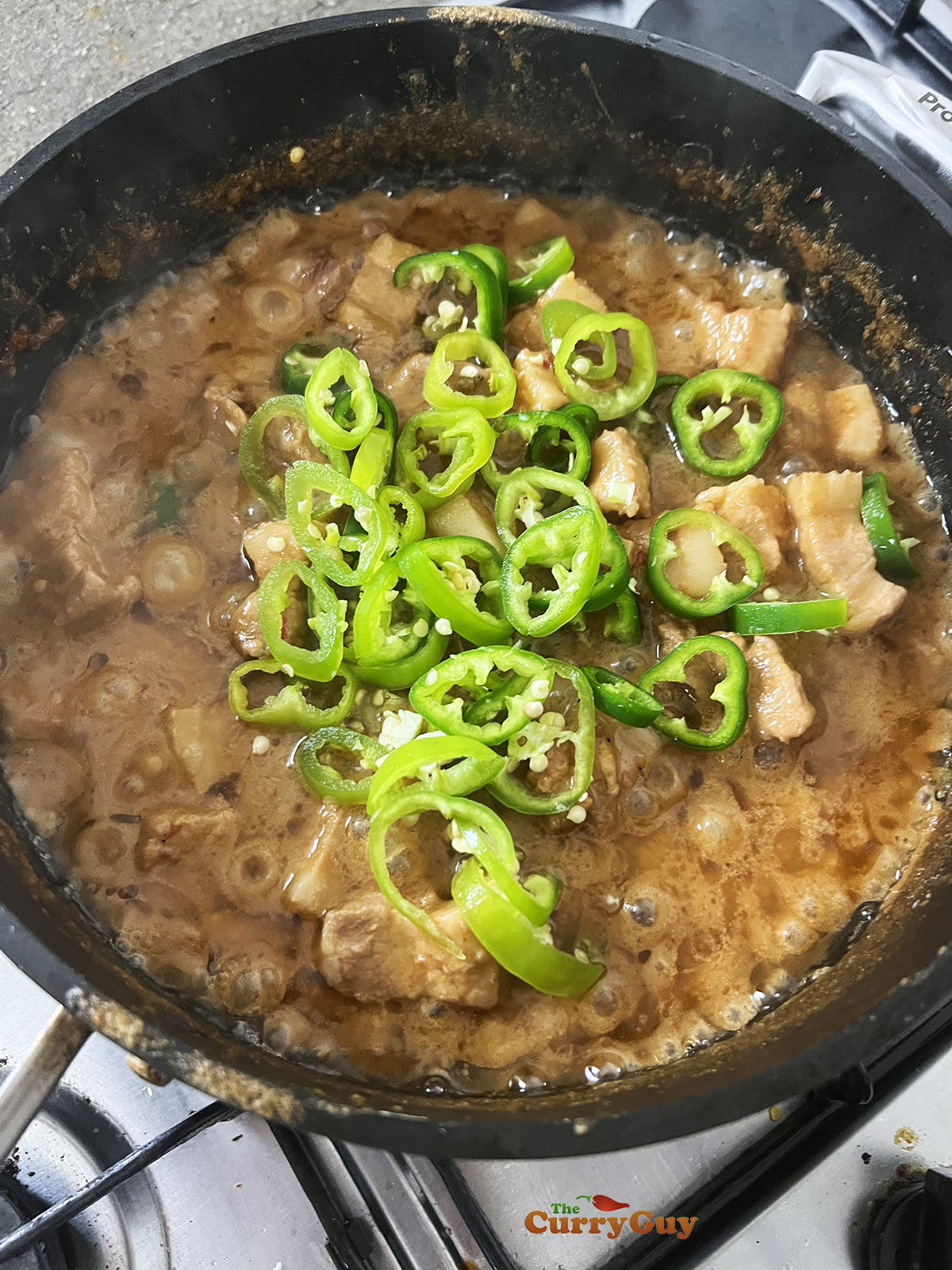 Stirring the green chillies to the pan