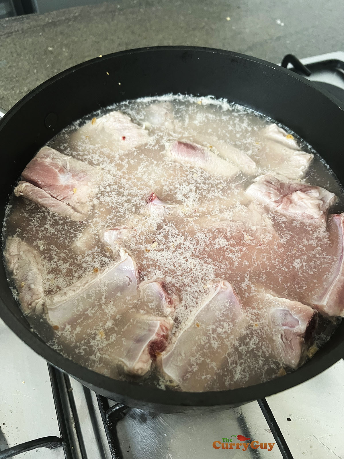 Simmering the ribs to clean them