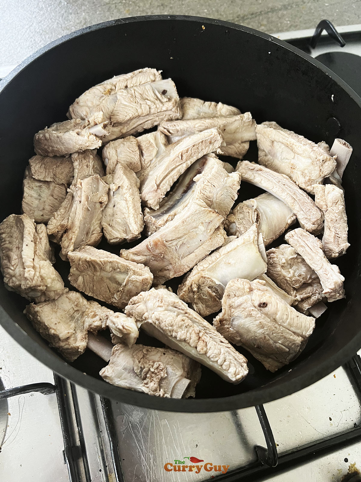 Placing the ribs back in the pan