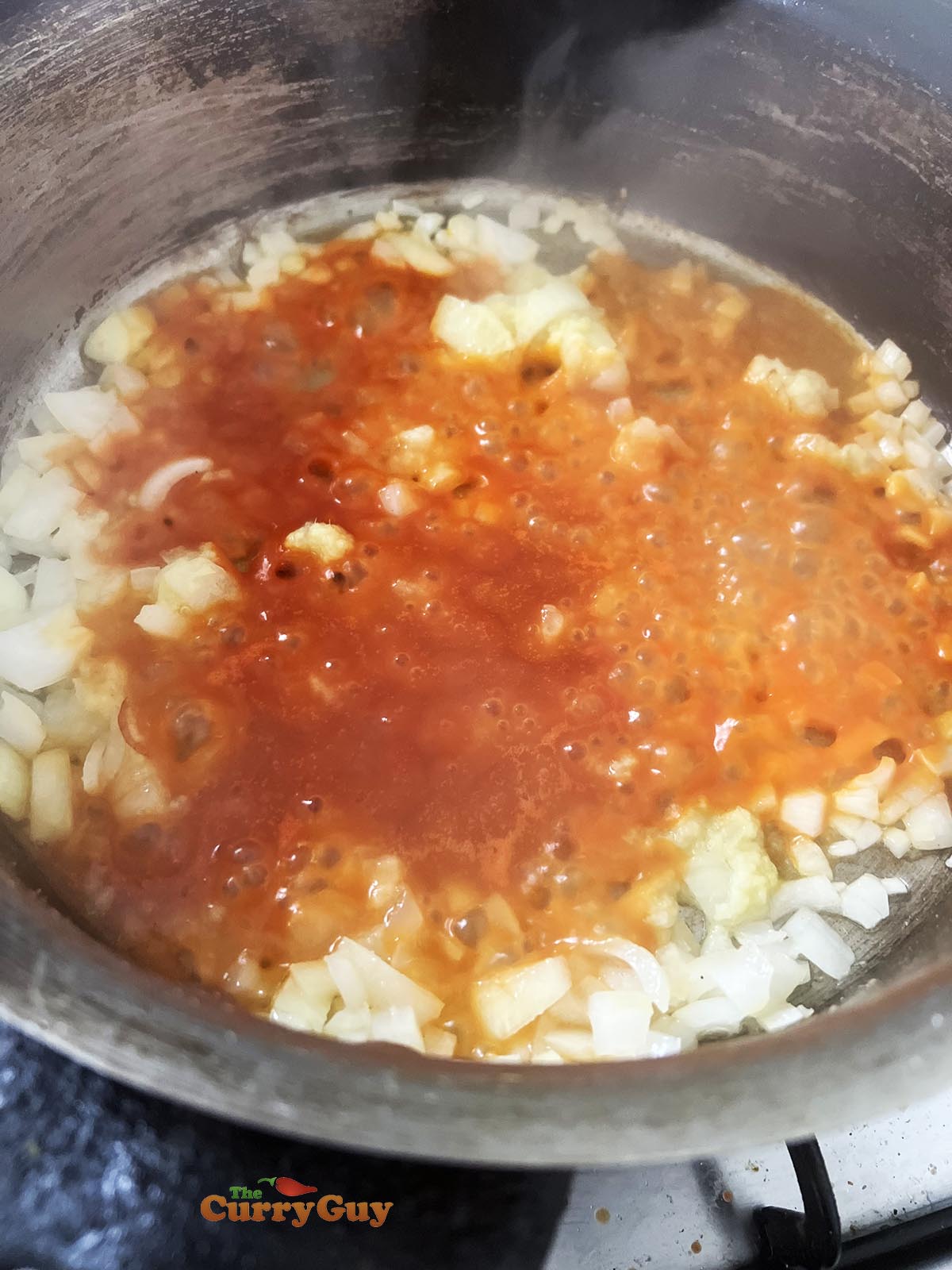 Adding tomatoes to the pan