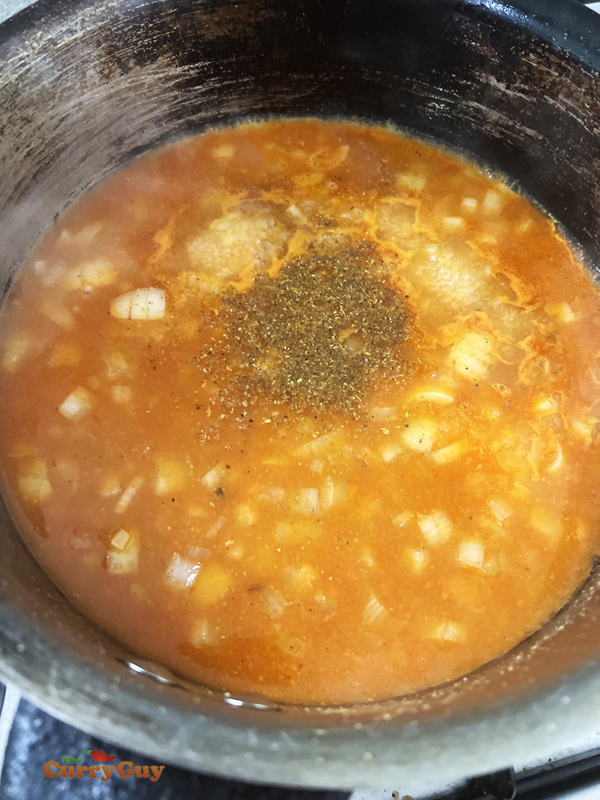 Adding spices and stock to the pan