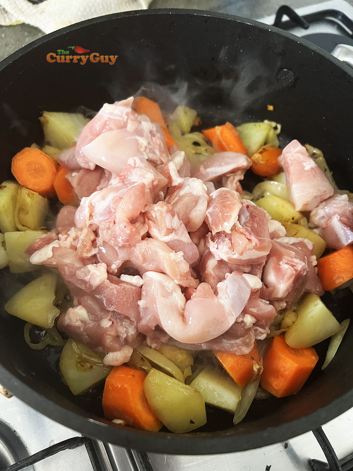 Adding chicken to the pan