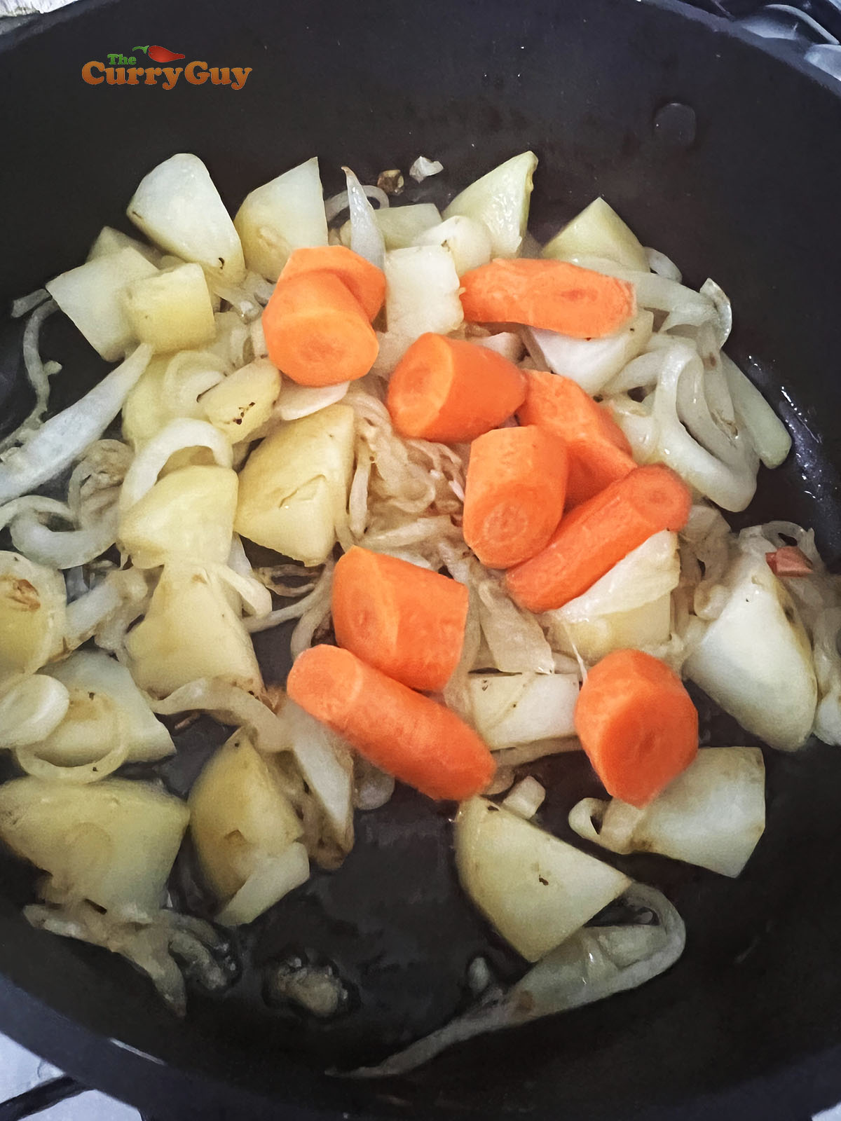 Adding carrots to the pan