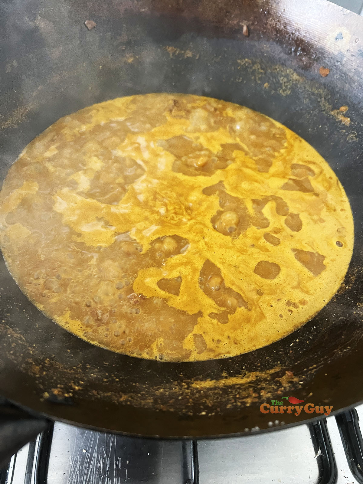 Finishing the beef khao soi