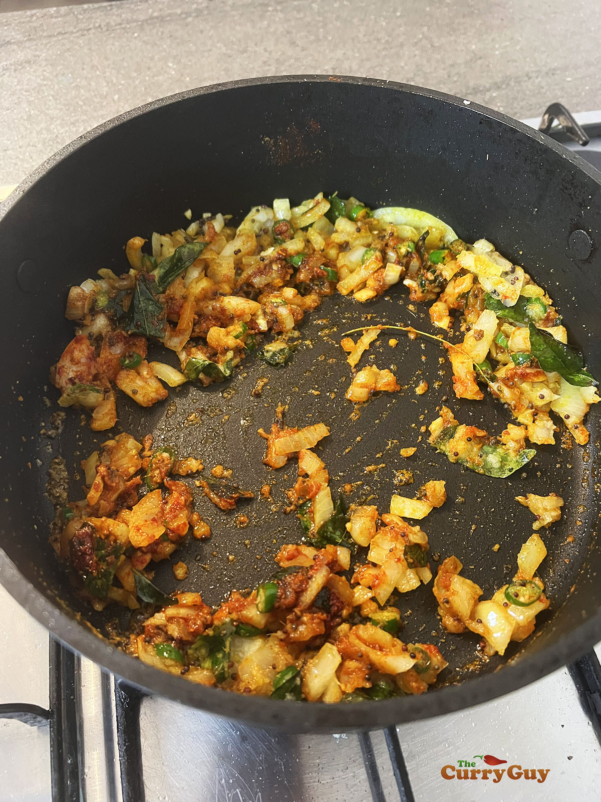 Adding ground spices to the pan