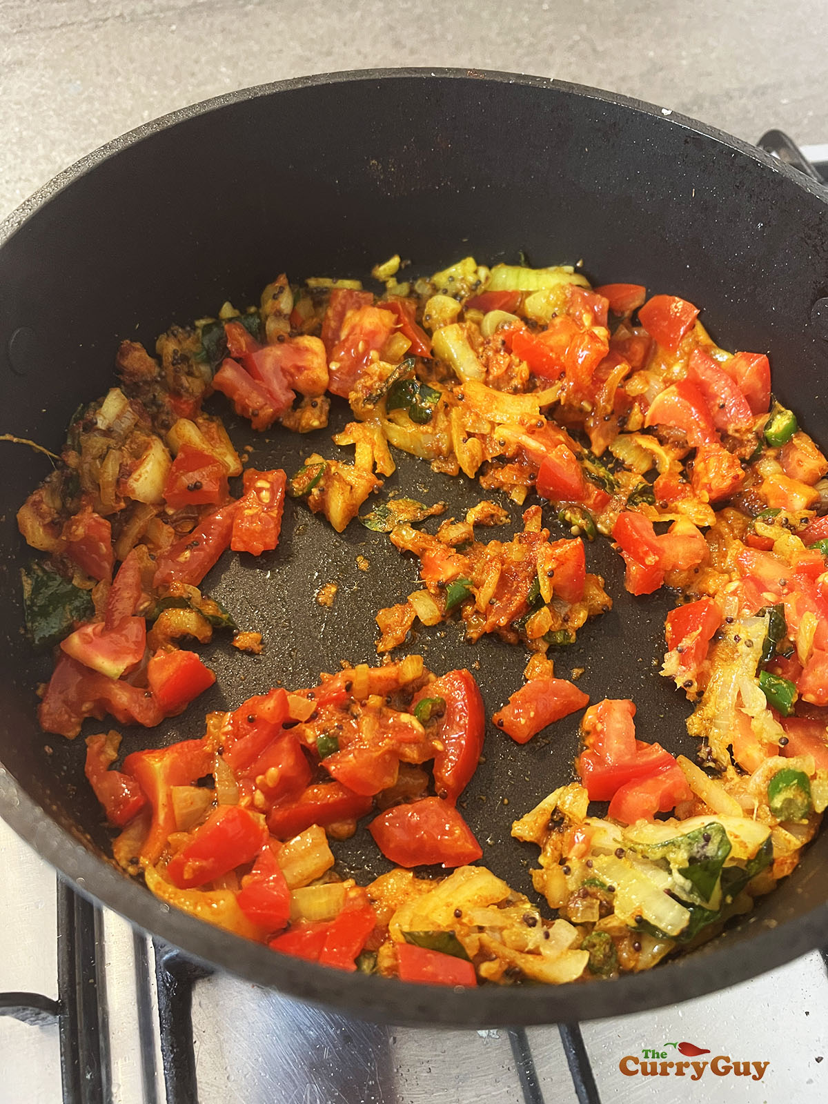 Stirring tomatoes into the onion mixture