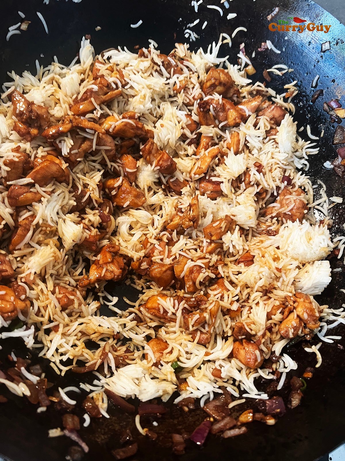 Adding cold rice to the wok