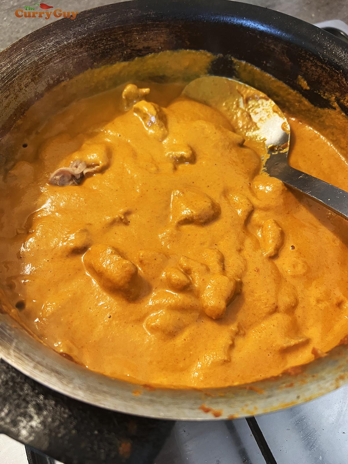 Simmering the lamb pieces in the smooth sauce