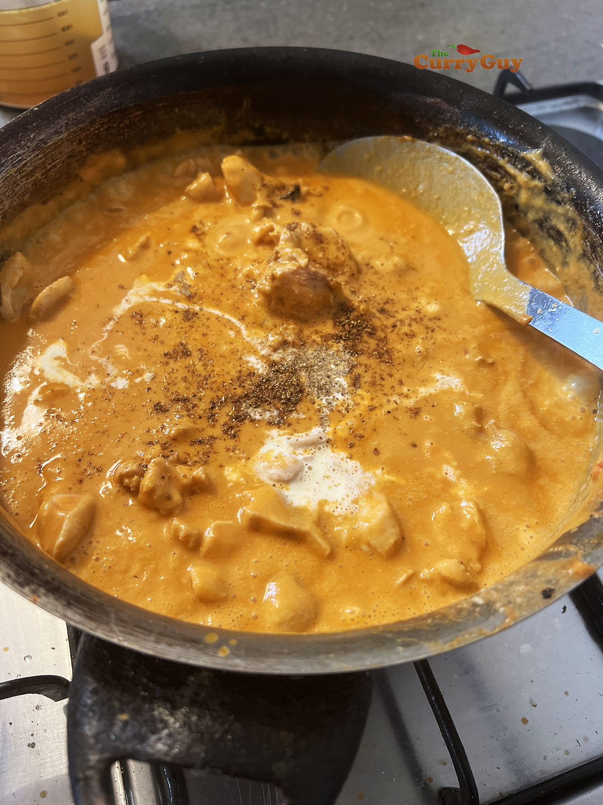 Adding cream and garam masala to the sauce