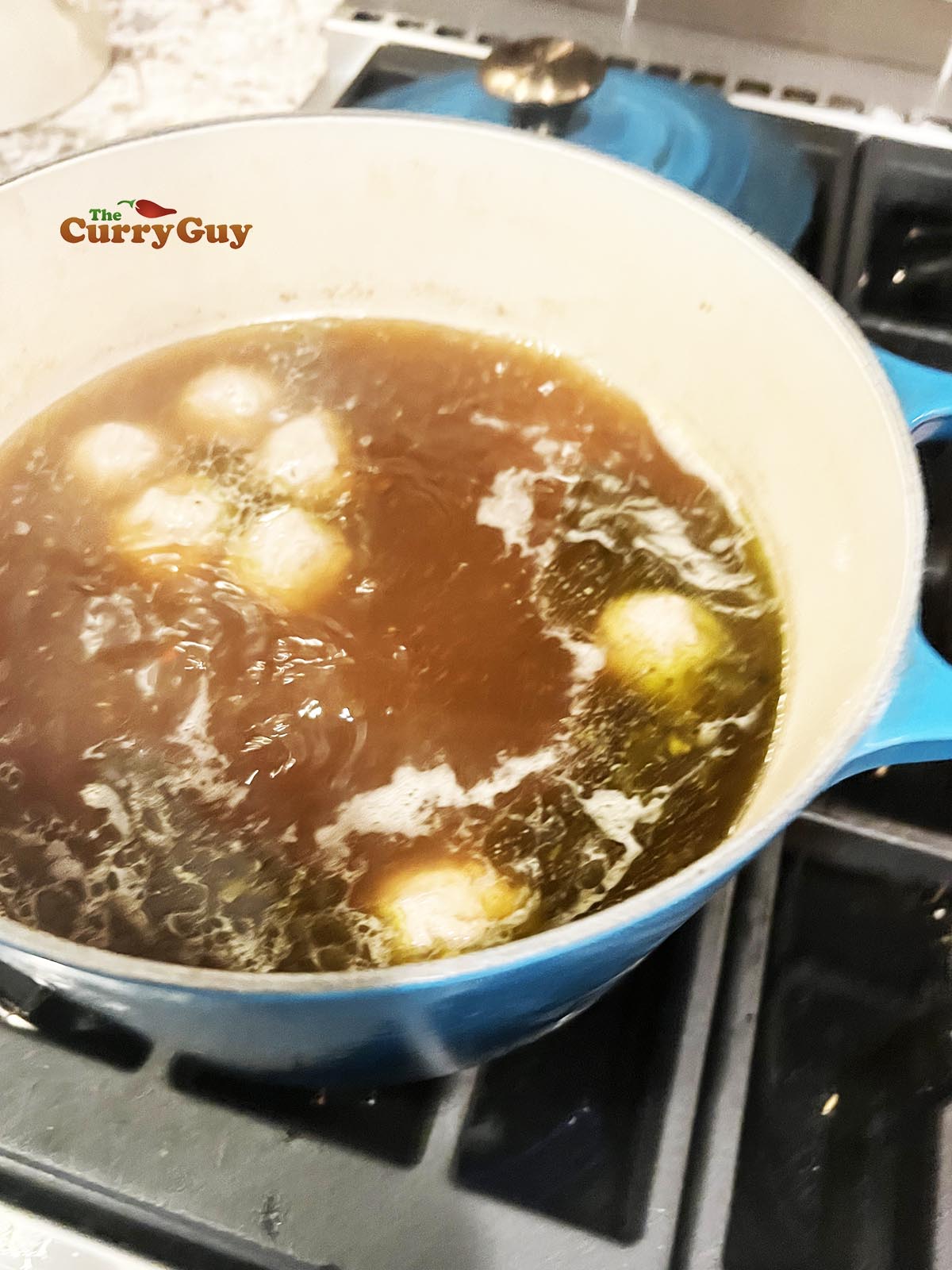 simmering meatballs in the stock
