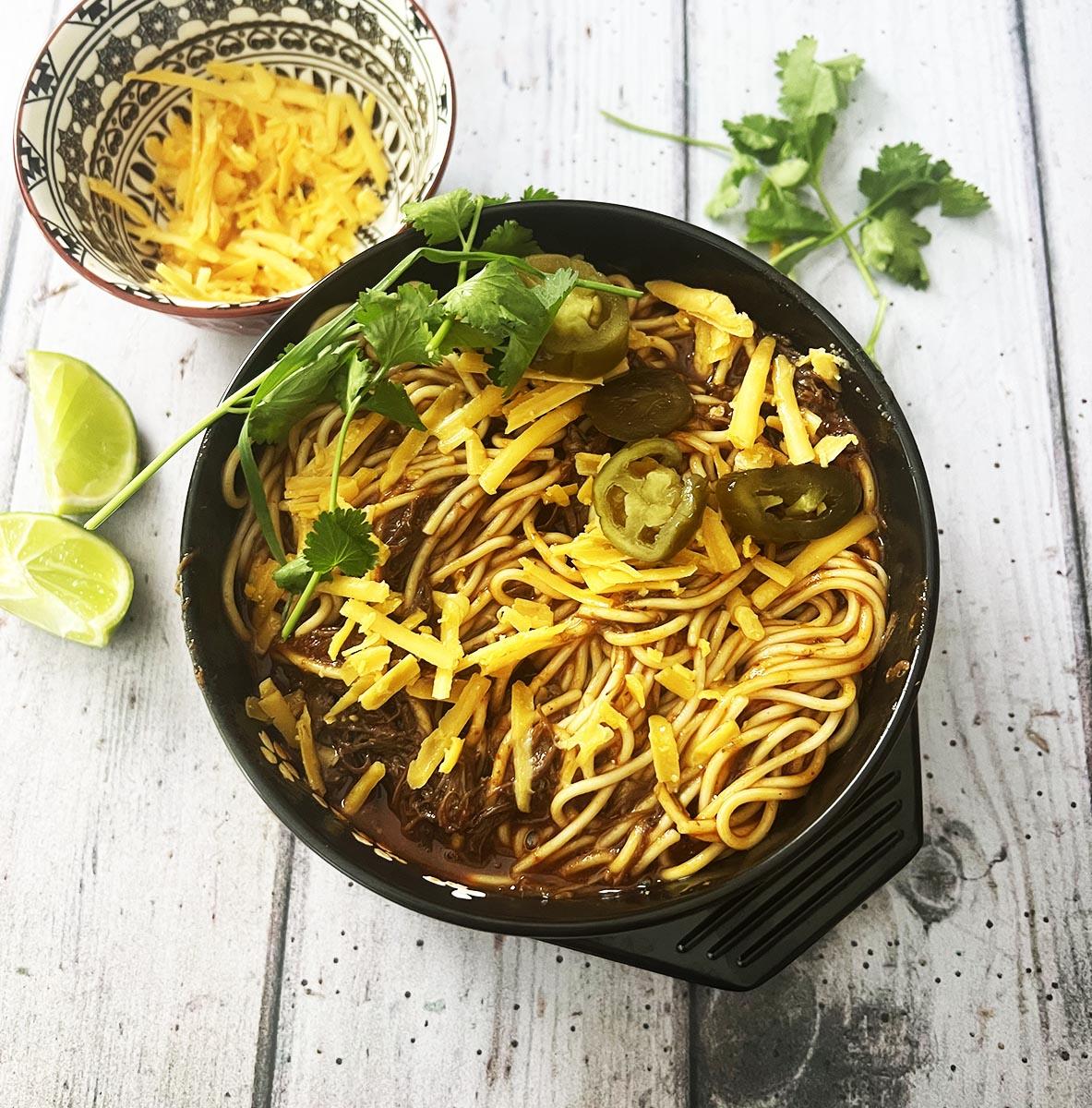 birria ramen in a bowl with garnishes