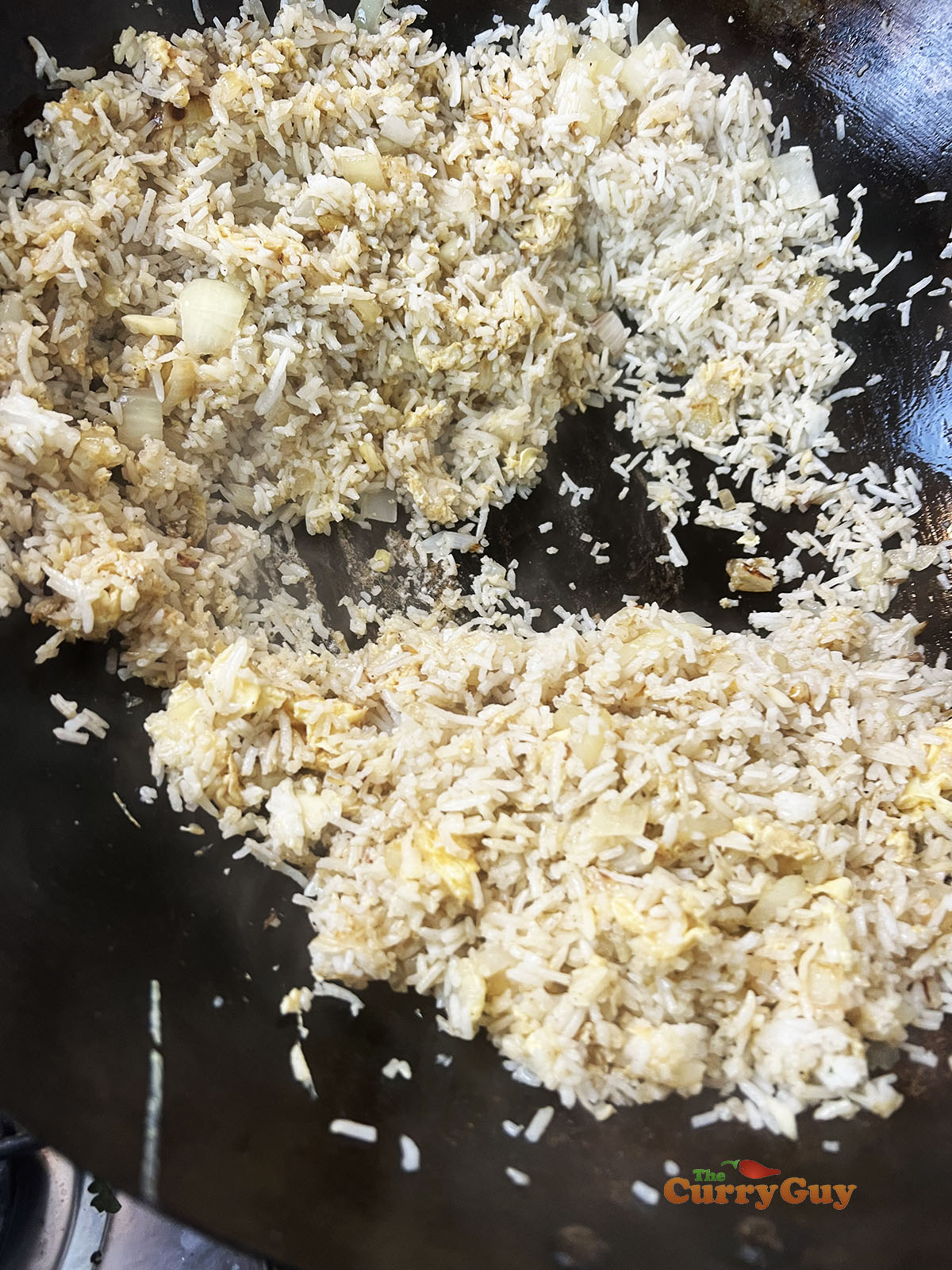 Stirring pepper and soy sauce into the rice