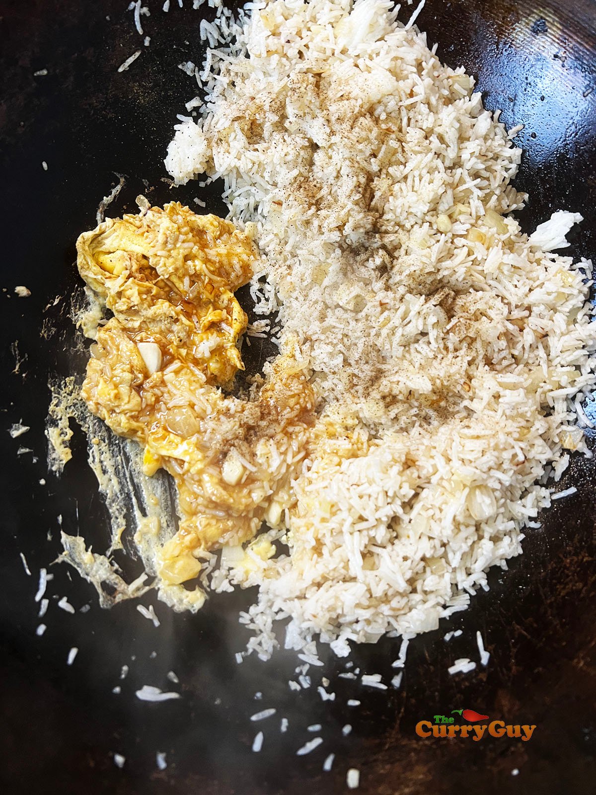 Scrambling the eggs and adding soy sauce