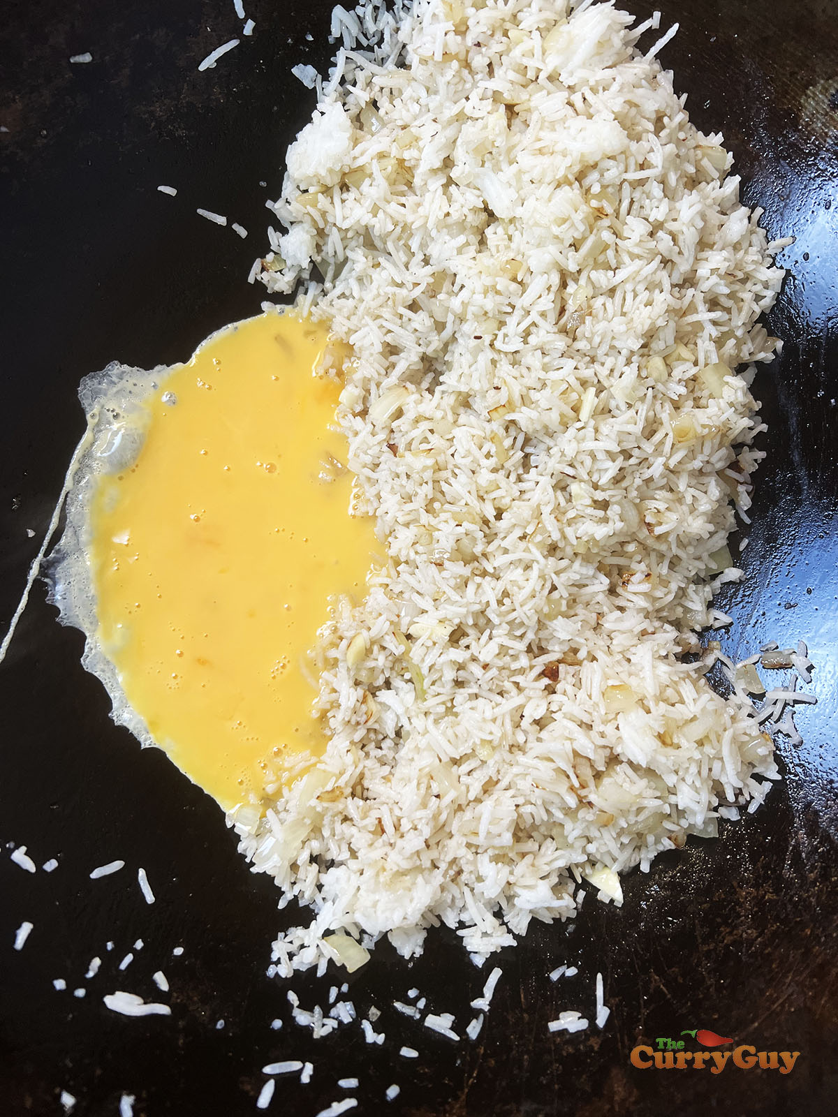 Adding eggs to the wok